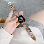 Canvas replacement strap for Apple Watch displayed on a wrist, featuring a camouflage design and comfortable fit.
